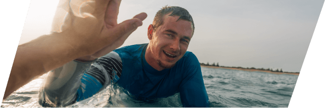 XCOPRI Epilepsy Patient High-Fiving Surfer in Ocean